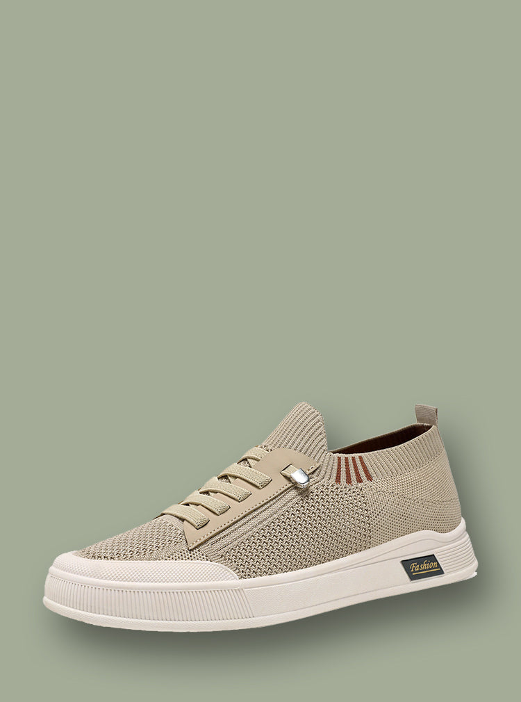 Beige sneaker with white sole on a green background